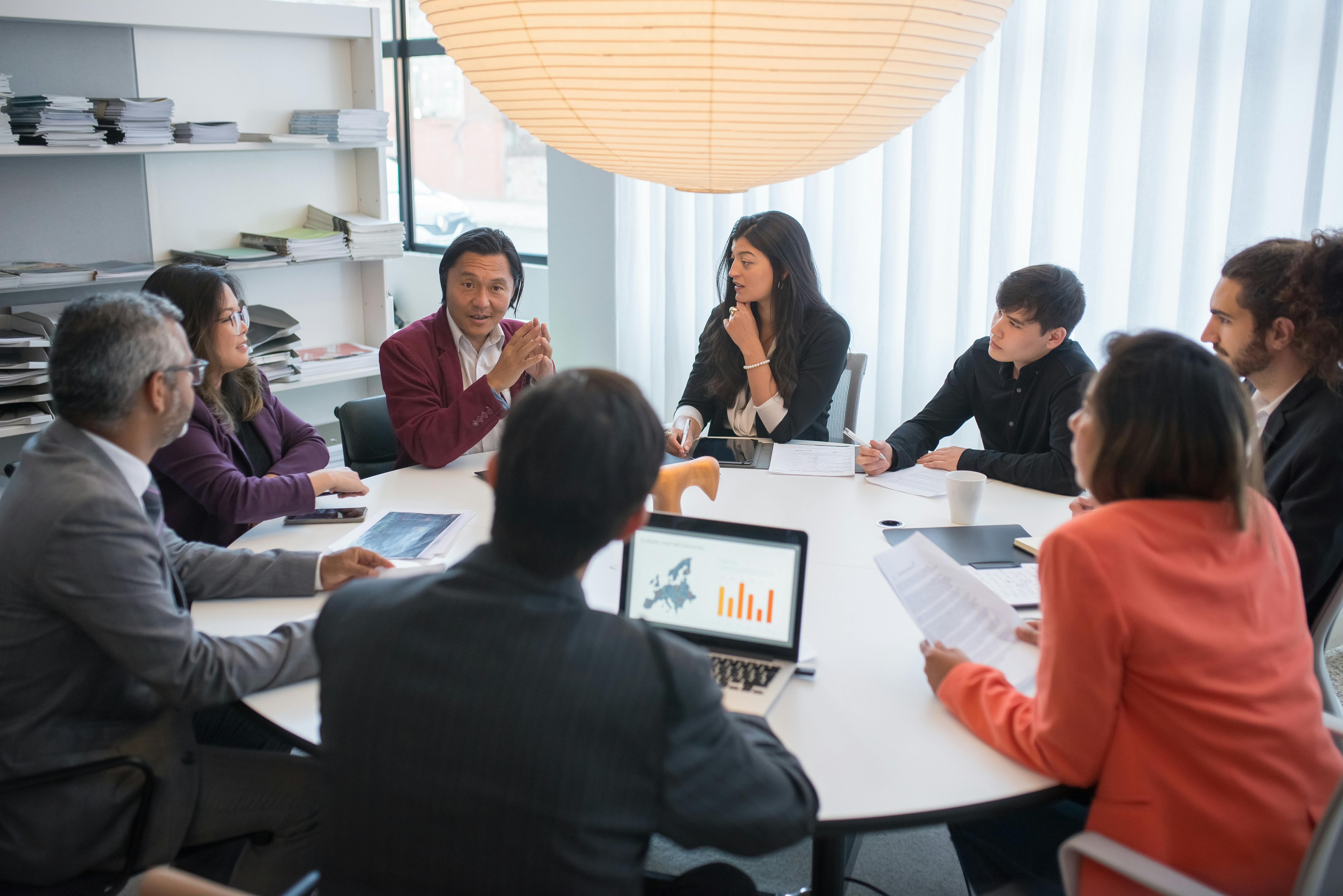 colleagues chatting around a desk