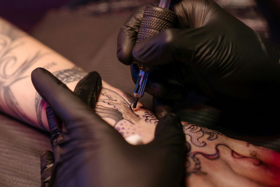 arm being tattooed